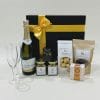Celebration Hamper image. Chardonnay pinot noir, flute glasses, chocolate coated macadamias, Shortbread & delicious nibbles. Ph 03 5174-4888