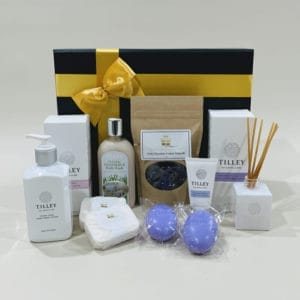 Harmony Hamper - indulgent treats, scented soaps and lotions, hand and body washes, lavender soap, hand and nail creams, reed diffusers, gourmet chocolates and nuts, gold-ribboned gift box.