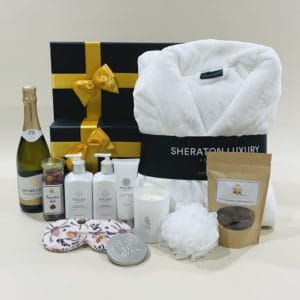 Womens Pamper Hamper image. Bathrobe, skincare, scented soy candle, choc coated macadamias, sparkling chardonnay. Online or Ph 03-5174-4888
