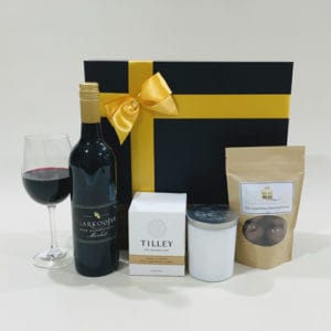 Gift Hamper For Friend image. Lemon grass soy candle, bottle of Merlot & chocolate coated almonds, to enjoy. Buy Online or Phone 03 51744888