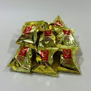 Garden Fortune Cookies x 8 Units. Gold foil packets holding fortune cookies with enigmatic messages, a Lunar New Year tradition for sharing insights.